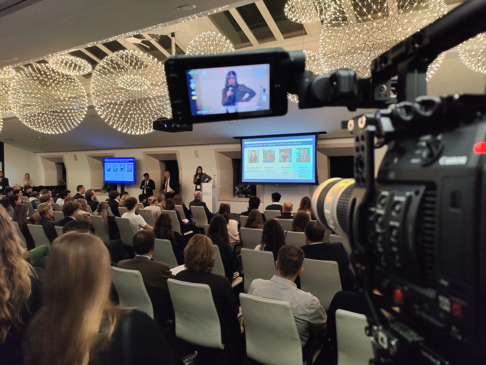 Filming a live event from the back of the room. Every card recorded on a day like this has to come off safely before anything is wiped.