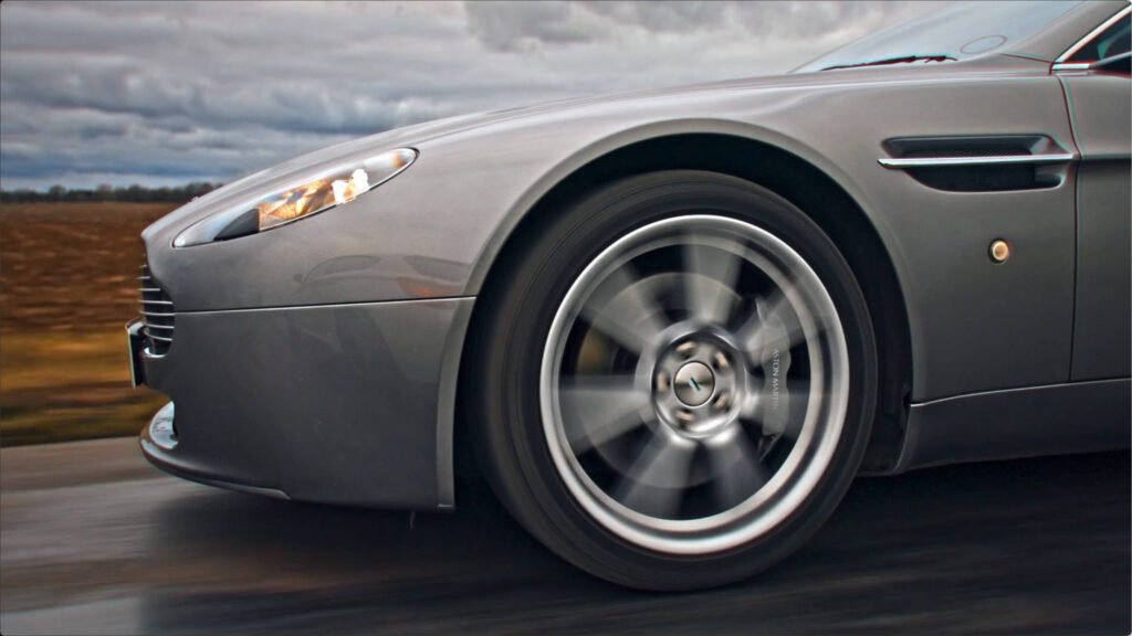 aston martin on road running from front left angle a quatre front wheel close up – Lumira Studio